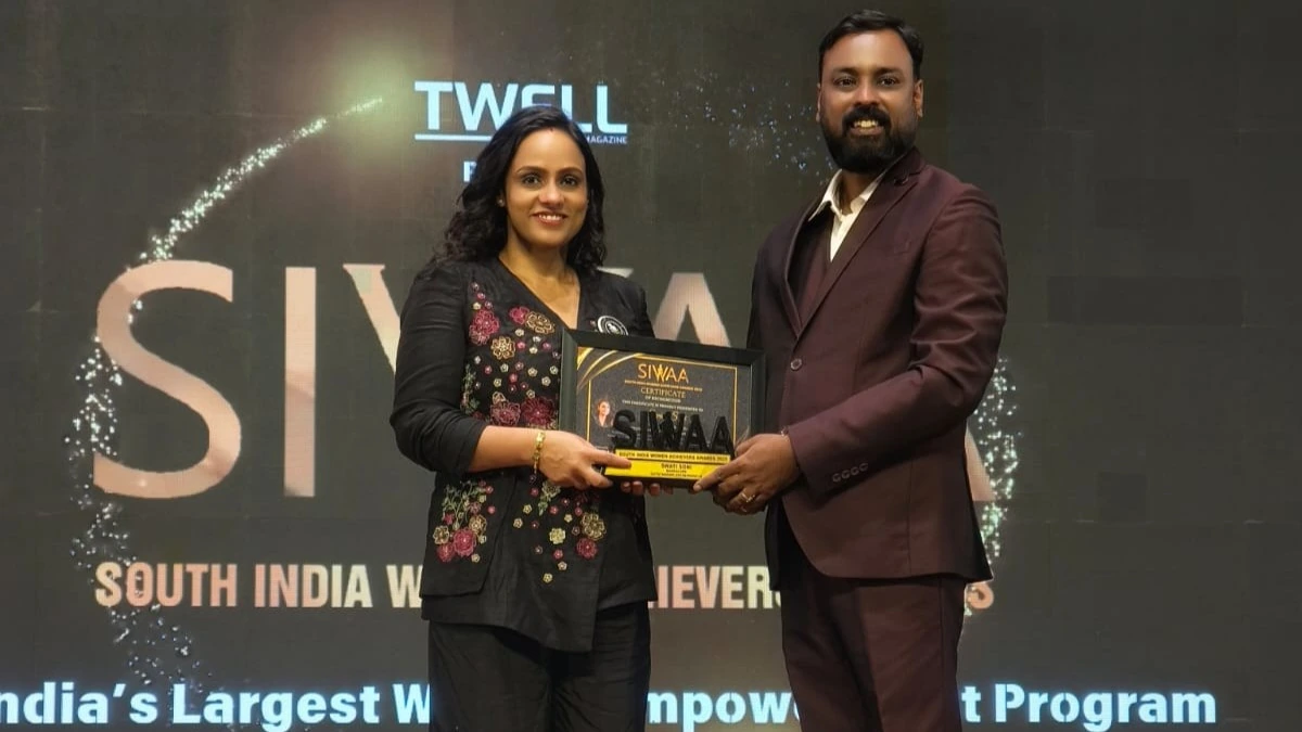 Swati receiving an award on stage